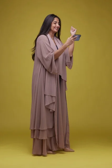 Young Saudi Woman Playing Game on Smartphone