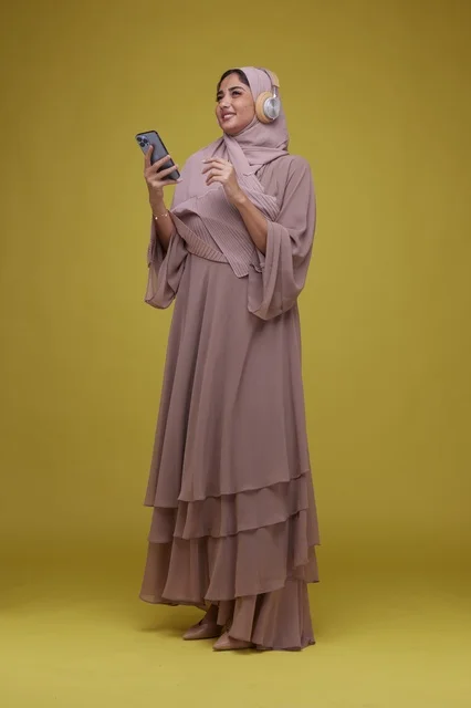 Young Saudi Woman Listening to Music with Smartphone