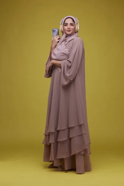 Saudi Woman with Headphones on Yellow Background
