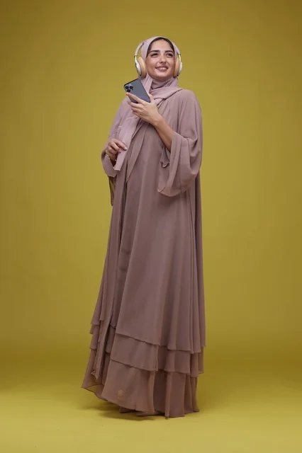 Saudi Woman Listening to Music on Yellow Background