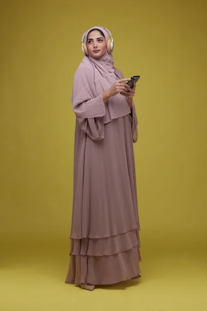 Saudi Woman with Headphones and Smartphone Studio Shot