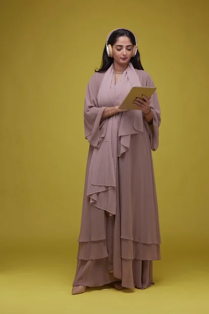 Young Saudi Woman Using Tablet with Headphones