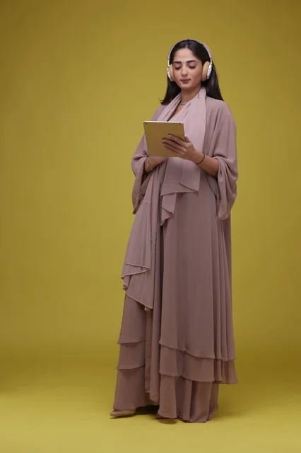 Saudi Woman with Tablet and Headphones in Studio