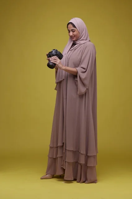 Saudi Woman Photographer with DSLR on Yellow Background