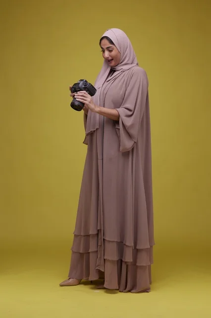 Saudi Woman Photographer with Camera on Yellow Background