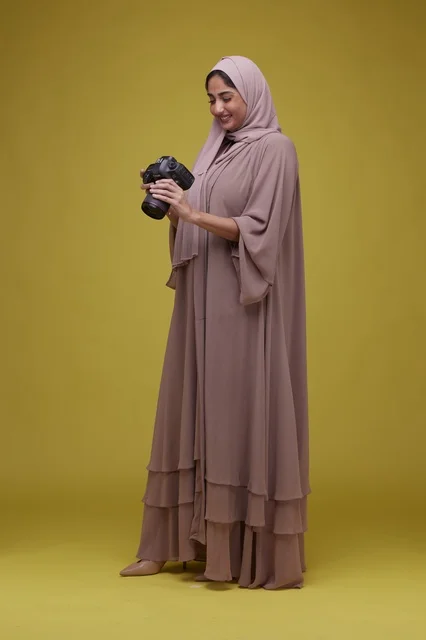 Saudi Woman Photographer with DSLR Camera Studio Shot