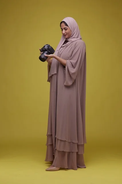 Saudi Woman Photographer with Camera on Yellow Background