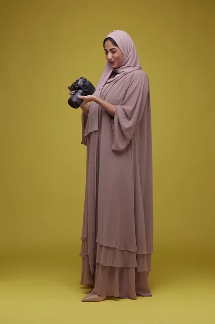 Saudi Woman Photographer Holding DSLR Camera in Studio