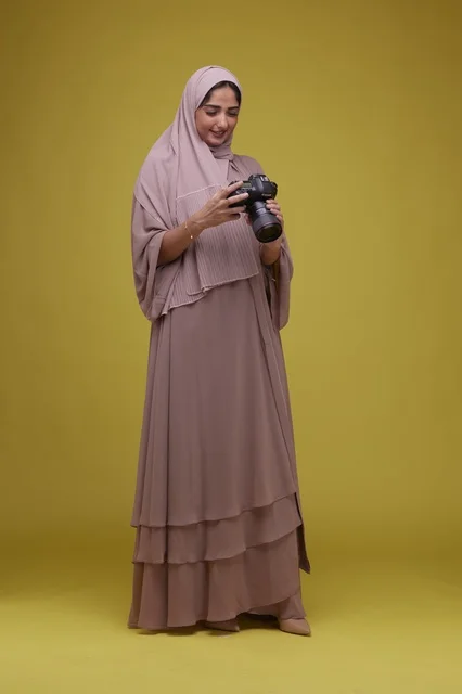 Saudi Woman Photographer with Camera in Studio