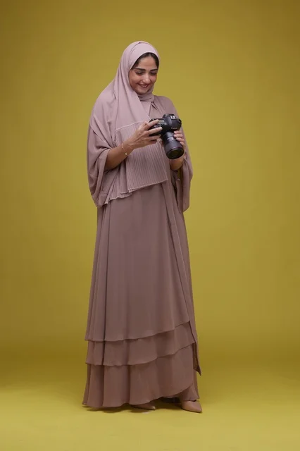 Saudi Woman Photographer with Camera on Yellow Background