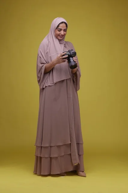 Saudi Woman Photographer with DSLR Camera on Yellow Background