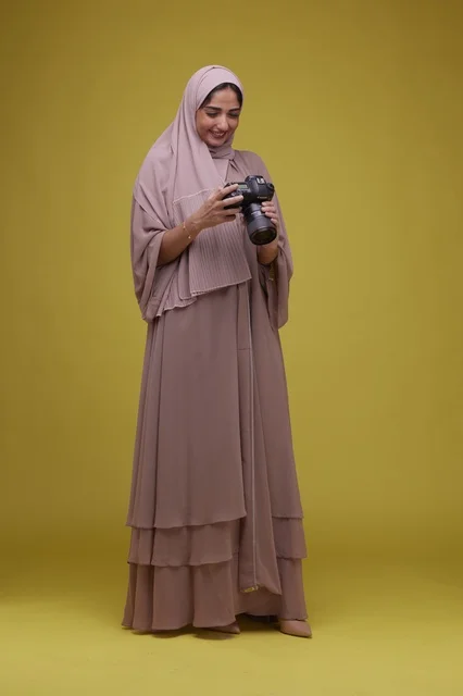 Saudi Woman Photographer with DSLR Camera on Yellow Background