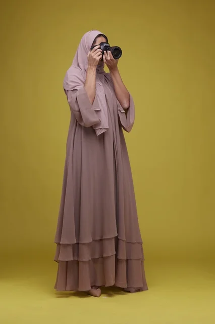Saudi Woman Photographer with Camera on Yellow Background