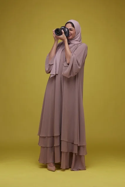 Saudi Woman Photographer with DSLR Camera in Studio