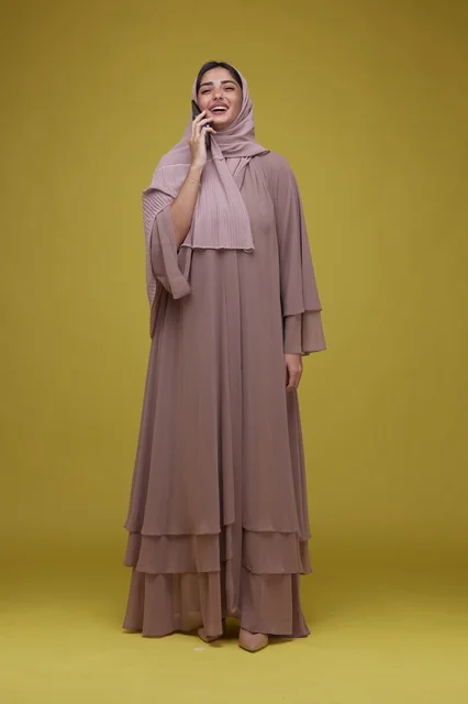 Saudi Woman Talking on Smartphone in Beige Abaya