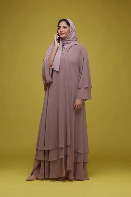 Saudi Woman in Beige Abaya Talking on Smartphone Studio
