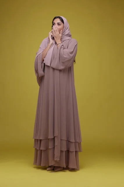 Saudi Woman with Abaya Talking on Smartphone Surprised