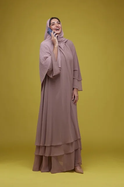 Saudi Woman in Beige Abaya Using Smartphone