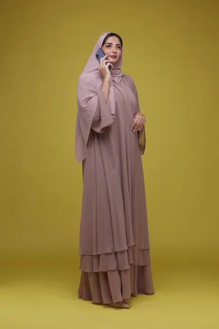 Saudi Woman Talking on Smartphone in Beige Abaya