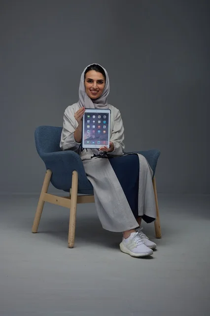 Saudi Woman Sitting Holding Digital Tablet in Studio