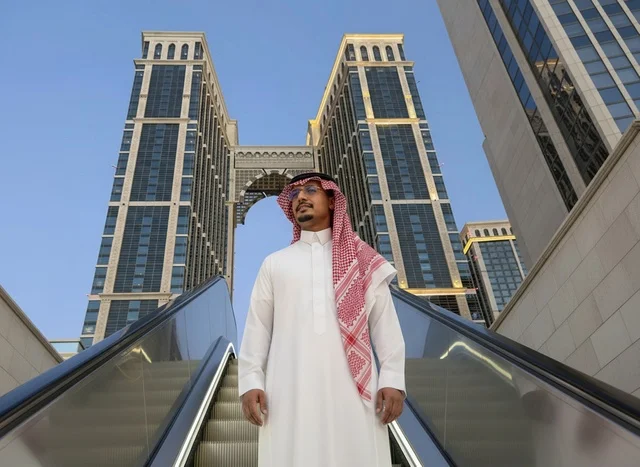 Saudi Man in Traditional Thobe at Modern Twin Towers