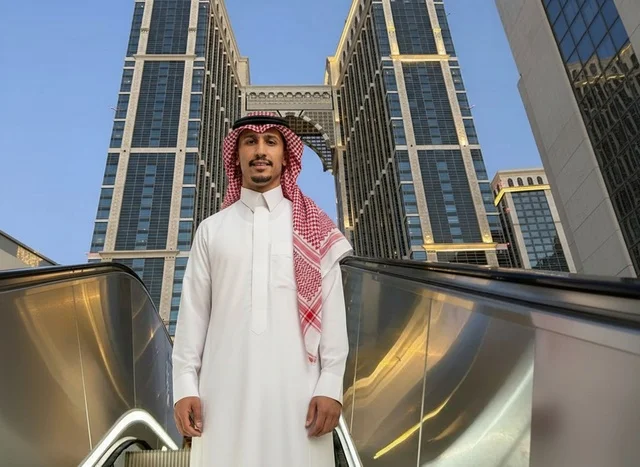 Saudi Man in Traditional Thobe on Urban City Escalator
