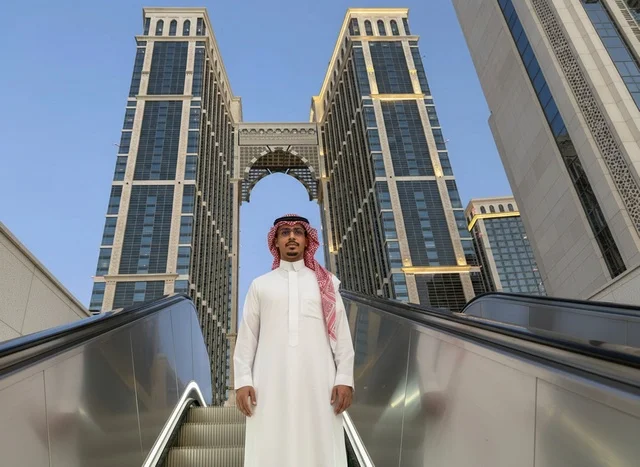 Saudi Man in Traditional Dress by Modern Skyscraper