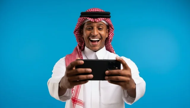 Saudi Man Using Smartphone on Blue Background