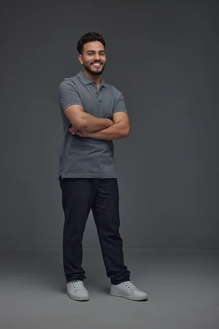 Smiling Saudi Man in Studio with Crossed Arms