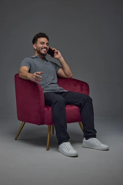 Saudi Man Talking on Smartphone in Red Armchair