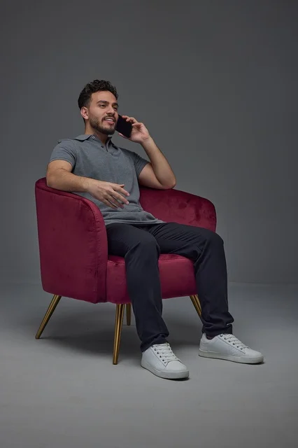 Saudi Man Talking on Smartphone in Armchair