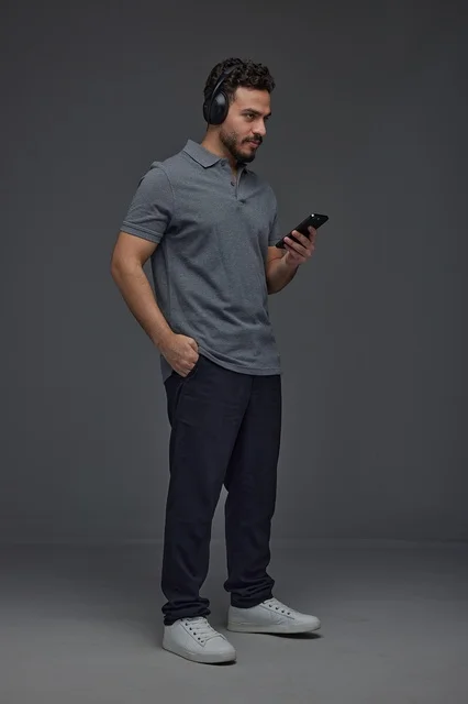 Saudi Man with Headphones and Smartphone in Studio