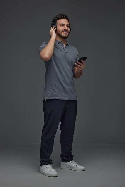 Saudi Man with Headphones and Smartphone in Studio
