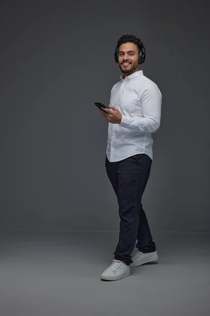 Saudi Man with Headphones and Smartphone in Studio