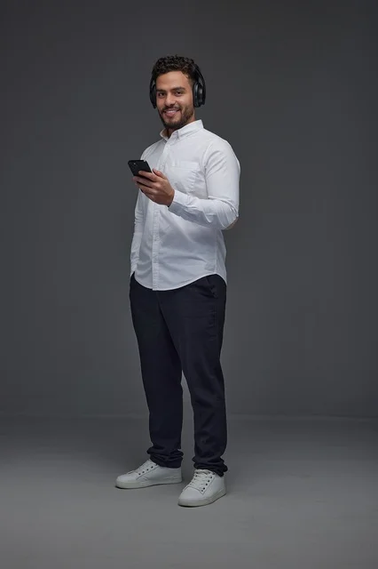 Saudi Man with Headphones and Smartphone in Studio