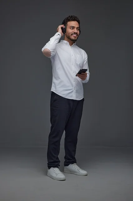 Saudi Man with Smartphone and Headphones in Studio