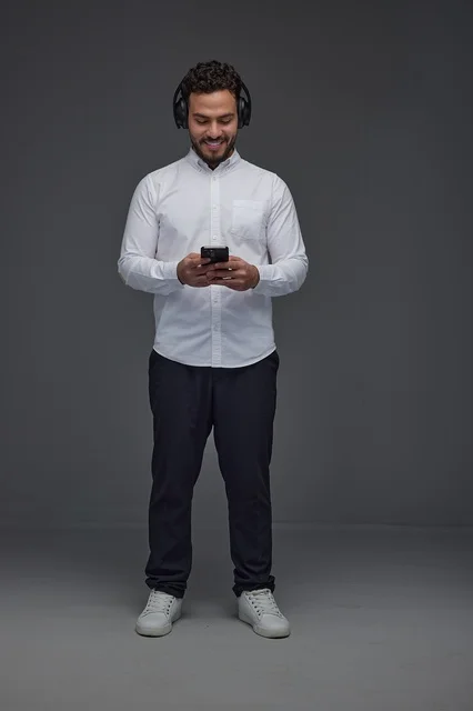Saudi Man in Studio Using Headphones and Smartphone