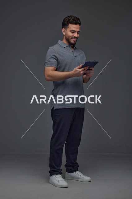 رجل سعودي يستخدم جهازًا لوحيًا في الاستوديو