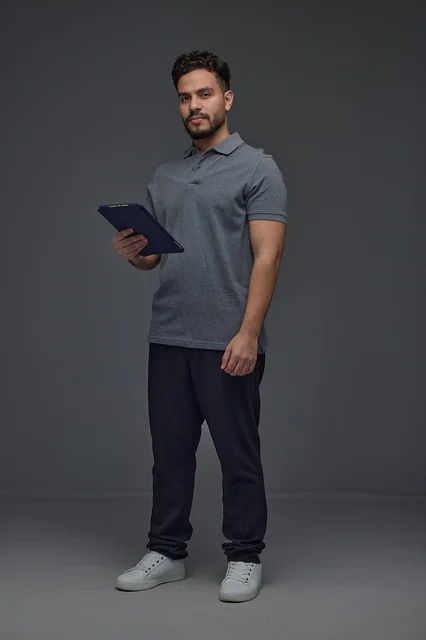 Saudi Man Holding Digital Tablet on Gray Background