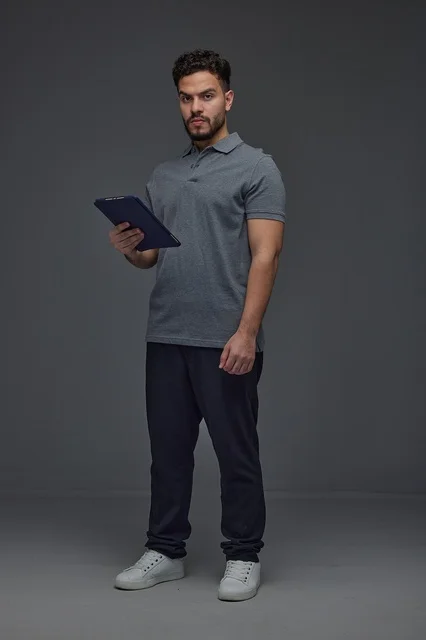 Saudi Man Holding Digital Tablet in Studio Setting