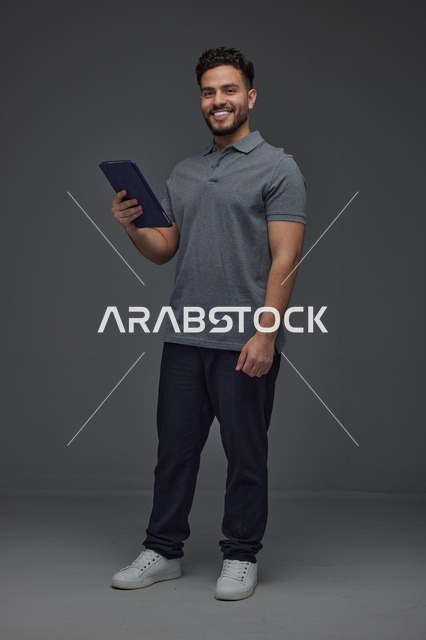 Saudi Man Holding Digital Tablet in Studio Portrait