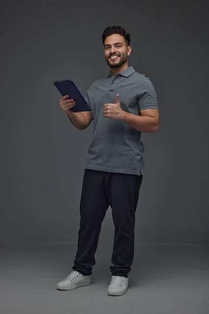 Saudi Man with Tablet Giving Thumbs Up in Studio