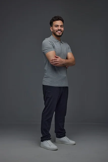 Smiling Saudi Man in Grey Polo Shirt Studio Portrait