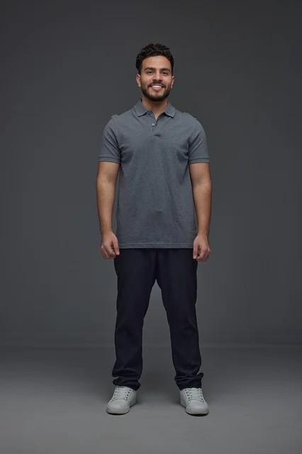 Smiling Saudi Man in Grey Polo Shirt Studio Portrait