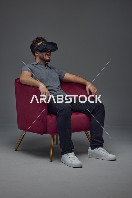 Saudi Man Wearing VR Headset in Studio Armchair