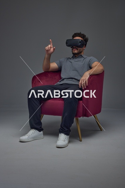 Saudi Man Wearing VR Headset in Studio Setting
