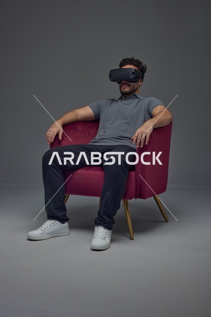 Saudi Man Using VR Headset in Armchair