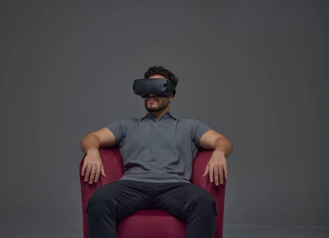 Man Using Virtual Reality Headset in Red Chair