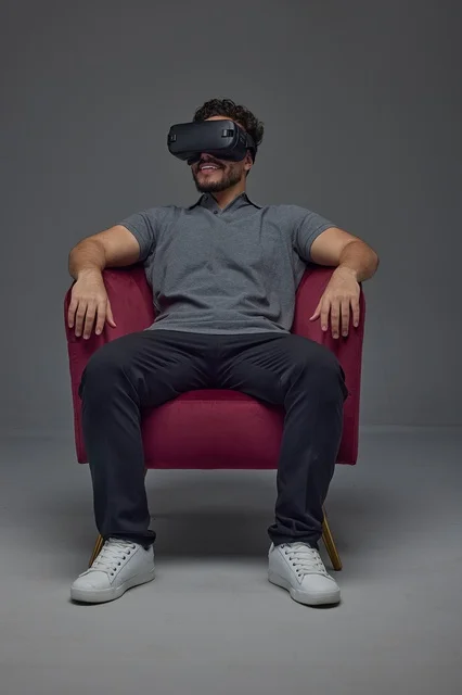 Saudi Man Wearing VR Headset in Studio Armchair