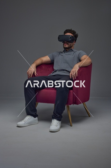 Saudi Man Using VR Headset in Armchair